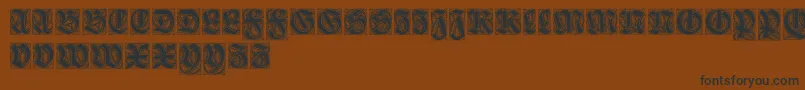 フォントEhmckeschwabacher – 黒い文字が茶色の背景にあります