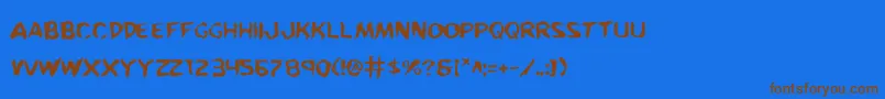 KreetureWarped-Schriftart – Braune Schriften auf blauem Hintergrund