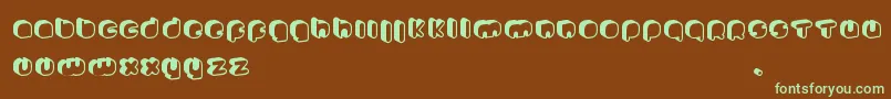 フォントJohannekePro – 緑色の文字が茶色の背景にあります。