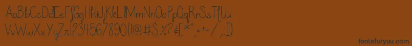 OurLilSecretForever-Schriftart – Schwarze Schriften auf braunem Hintergrund