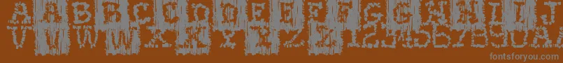 Fonte Stoneflint – fontes cinzas em um fundo marrom