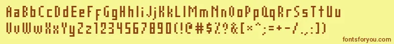 フォントAuxDotbitcCompressed – 茶色の文字が黄色の背景にあります。