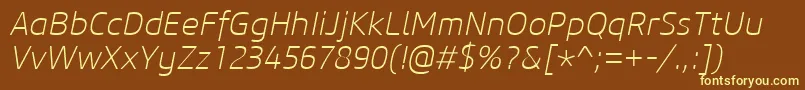 CoreSansM25ExtralightItalic-fontti – keltaiset fontit ruskealla taustalla