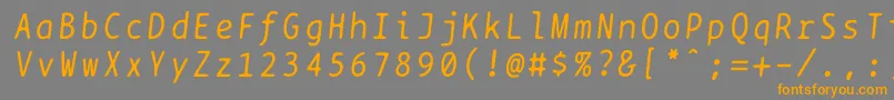 フォントBptypewriteitalics – オレンジの文字は灰色の背景にあります。