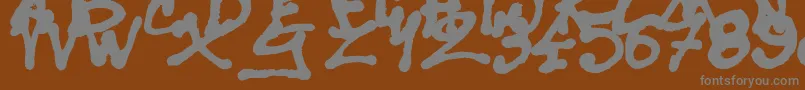 フォントSisterSpray – 茶色の背景に灰色の文字