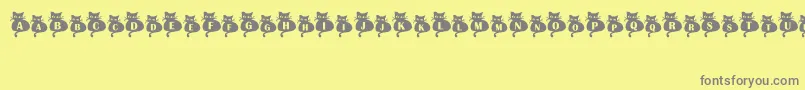 フォントNineLives – 黄色の背景に灰色の文字