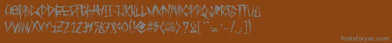 フォントTribalThreat – 茶色の背景に灰色の文字