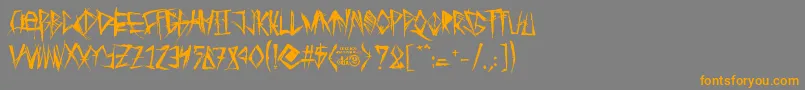フォントTribalThreat – オレンジの文字は灰色の背景にあります。