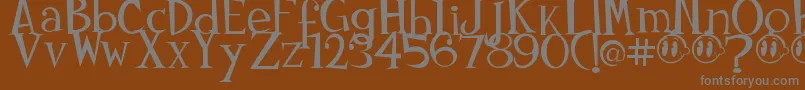 Johnyokonysm-fontti – harmaat kirjasimet ruskealla taustalla