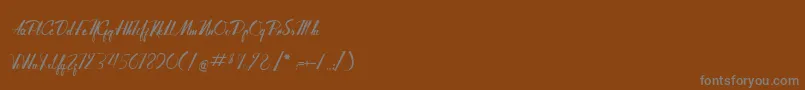 Czcionka AdventureOfTheOldGiant – szare czcionki na brązowym tle