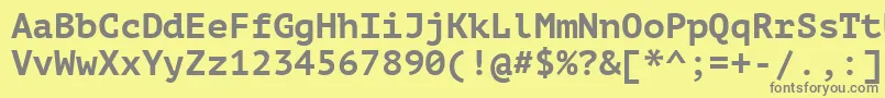Ptm75fW-fontti – harmaat kirjasimet keltaisella taustalla