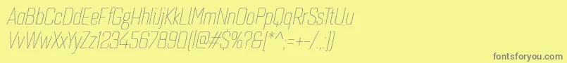 フォントQuarcacondthinitalic – 黄色の背景に灰色の文字