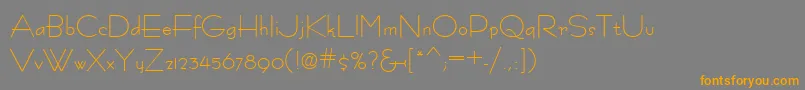 フォントFastracfashion – オレンジの文字は灰色の背景にあります。