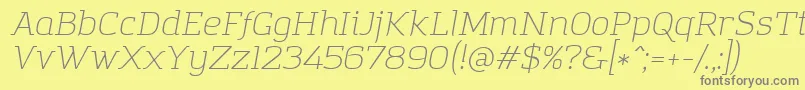 AmazingGroteskLightItalic-fontti – harmaat kirjasimet keltaisella taustalla