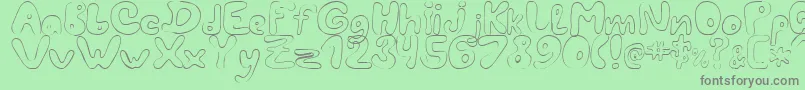 LcBlowzy-fontti – harmaat kirjasimet vihreällä taustalla