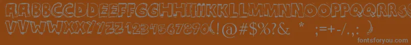 Maniatic-fontti – harmaat kirjasimet ruskealla taustalla