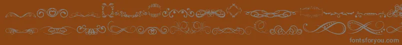 Шрифт AnotherOrnamentsTfb – серые шрифты на коричневом фоне