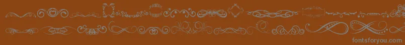 AnotherOrnamentsTfb-Schriftart – Graue Schriften auf braunem Hintergrund