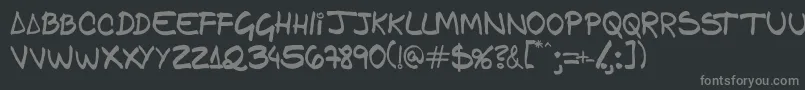 Gfamcomic-fontti – harmaat kirjasimet mustalla taustalla