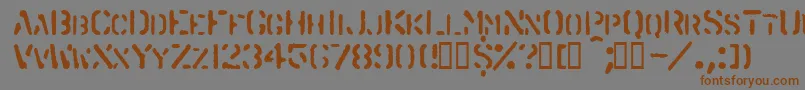 フォントSpraystencil – 茶色の文字が灰色の背景にあります。