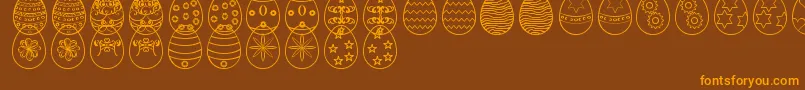 Czcionka EasterEggsSt – pomarańczowe czcionki na brązowym tle