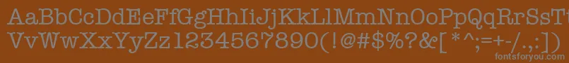 Amtypewritermditctt-fontti – harmaat kirjasimet ruskealla taustalla