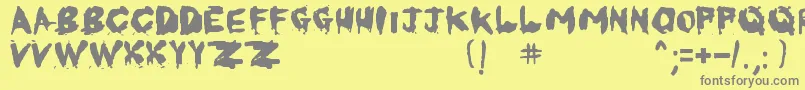フォントKornnetTooItTalitm – 黄色の背景に灰色の文字