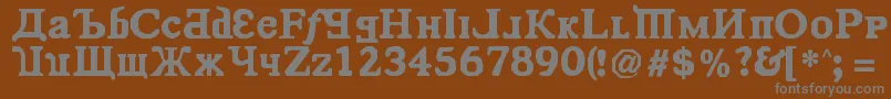 KremlinComrade-fontti – harmaat kirjasimet ruskealla taustalla