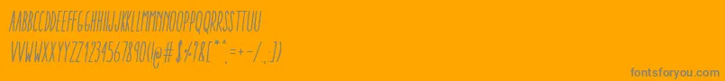 Czcionka AracneUltraCondensedRegularItalic – szare czcionki na pomarańczowym tle