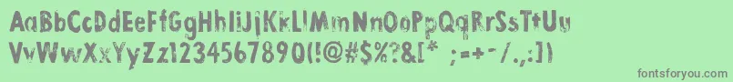LinoStamp-Schriftart – Graue Schriften auf grünem Hintergrund