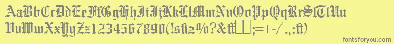 E780BlackletterRegular-fontti – harmaat kirjasimet keltaisella taustalla