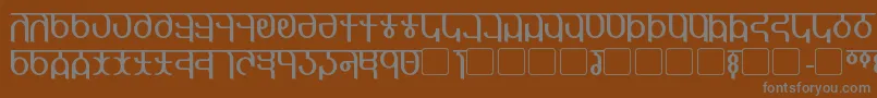Qijomi-fontti – harmaat kirjasimet ruskealla taustalla