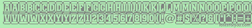 AMonumentottldccm-fontti – harmaat kirjasimet vihreällä taustalla
