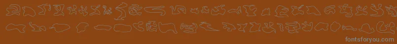 Cisfcamouflagekitouln-Schriftart – Graue Schriften auf braunem Hintergrund