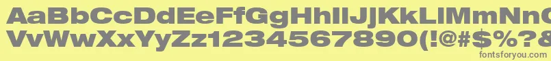 フォントHelveticaLt93BlackExtended – 黄色の背景に灰色の文字