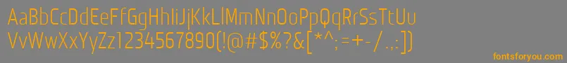 フォントMonitoricaRg – オレンジの文字は灰色の背景にあります。