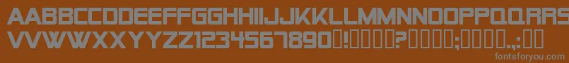AlienEncountersSolidBold-fontti – harmaat kirjasimet ruskealla taustalla