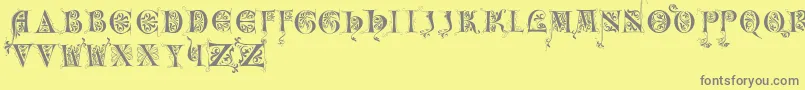 Incunitials Font – Gray Fonts on Yellow Background