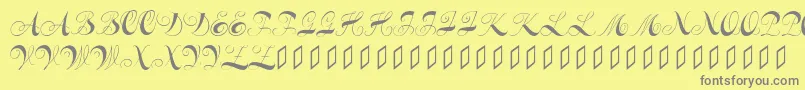 フォントConstanzeinitials – 黄色の背景に灰色の文字