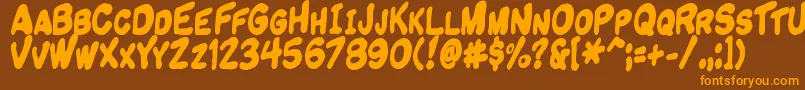 フォントKomikandy – オレンジ色の文字が茶色の背景にあります。