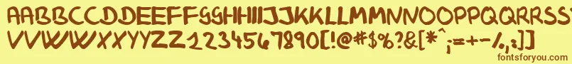 フォントKlausj – 茶色の文字が黄色の背景にあります。