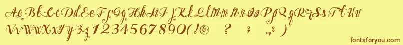 フォントOzhFont – 茶色の文字が黄色の背景にあります。
