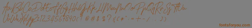 フォントHamilltonDemo – 茶色の文字が灰色の背景にあります。