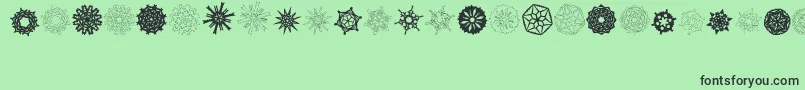 Fonte PaperSnowflakes – fontes pretas em um fundo verde