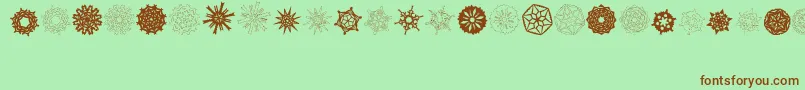 fuente PaperSnowflakes – Fuentes Marrones Sobre Fondo Verde