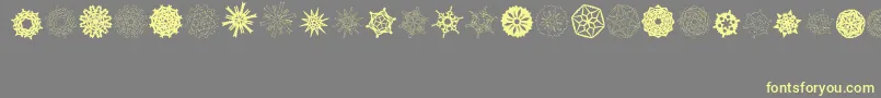 Шрифт PaperSnowflakes – жёлтые шрифты на сером фоне