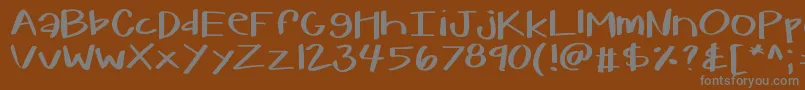 フォントKbwarmherup – 茶色の背景に灰色の文字