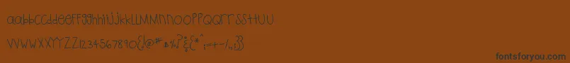 MtfPlaytime-Schriftart – Schwarze Schriften auf braunem Hintergrund