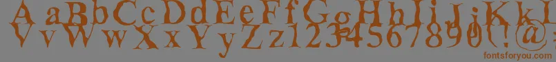 フォントDecomposing – 茶色の文字が灰色の背景にあります。