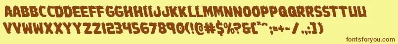 フォントJohnnytorchleft – 茶色の文字が黄色の背景にあります。